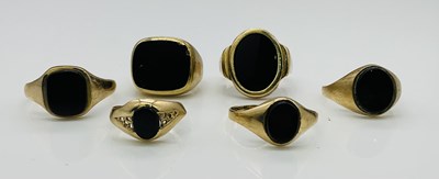 Lot 1057 - Six 9ct gold black onyx signet rings, combined...