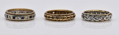 Lot 1067 - Three 9ct gold eternity rings, combined approx...