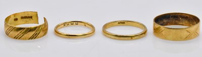 Lot 1069 - Four 18ct gold wedding bands, combined approx...
