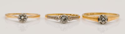 Lot 1071 - Three 18ct gold single stone diamind rings,...