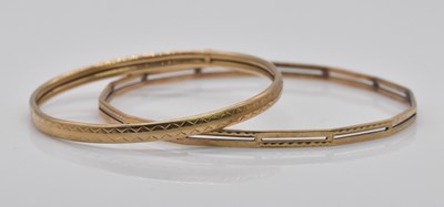 Lot 1075 - Two 9ct gold bangles, combined approx 17.8g.