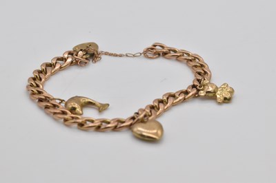 Lot 1079 - A 9ct gold curb link charm bracelet, approx 11....