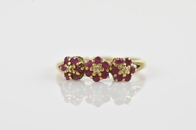 Lot 545 - A 9ct yellow gold dress ring, set with red...