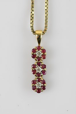 Lot 542 - A yellow metal pendant set with red coloured...
