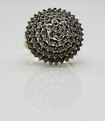 Lot 740 - A 9ct yellow gold domed circular target ring,...