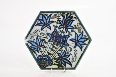 Lot 1896 - An Iznik hexagonal tile with floral decoration,...