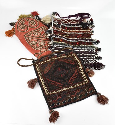 Lot 1548 - An Eastern saddle bag decorated with beads and...