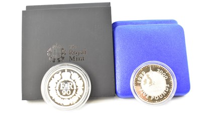 Lot 975 - THE ROYAL MINT; two silver £5 coins,...