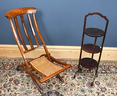 Lot 2922 - A cane seated folding chair and a three tier...