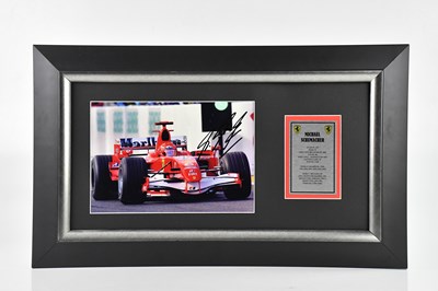 Lot 1495 - MICHAEL SCHUMACHER; a framed display featuring...