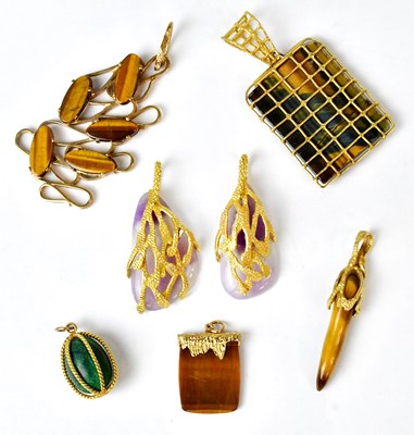Lot 1102 - Seven 9ct gold and yellow metal pendants, set...