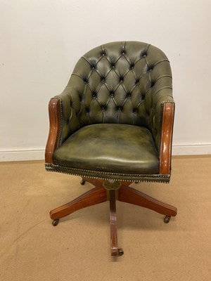 Lot 2824 - A button back leather office swivel chair, 94cm.