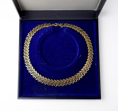 Lot 1113 - A 9ct gold bark-effect link bracelet stamped...