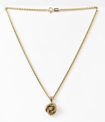 Lot 1104 - A 9ct yellow gold diamond set pendant on a 9ct...
