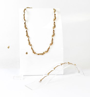 Lot 1122 - A 9ct yellow gold four-piece suite of...