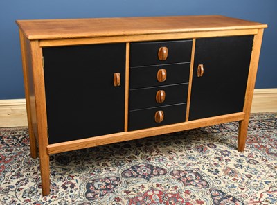Lot 1413 - GORDON RUSSELL; an oak sideboard with four...