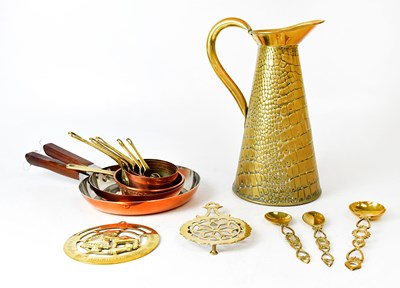 Lot 890 - A set of brass cooking pans, two brass trivets,...
