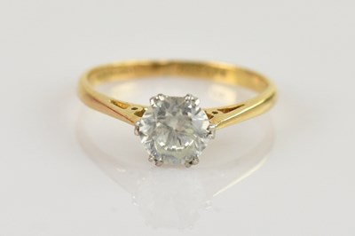 Lot 517 - An 18ct gold solitaire ring, with cut white...