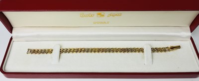 Lot 814 - An 18ct two tone gold flat link bracelet,...