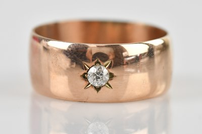 Lot 490 - A wide 9ct rose gold band ring with central...