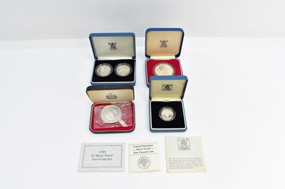 Lot 998 - THE ROYAL MINT; four cased silver coin sets,...