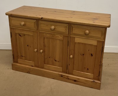 Lot 2834 - A pine sideboard of three drawers, above three...