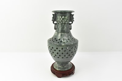 Lot 190 - A green carved hardstone vase with mottled...