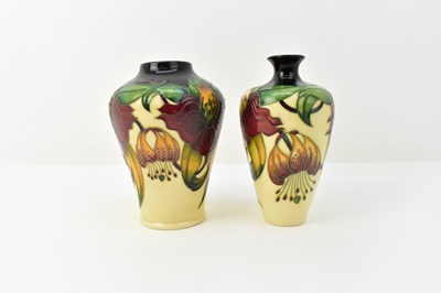 Lot 131 - MOORCROFT; two vases decorated in the 'Anna...