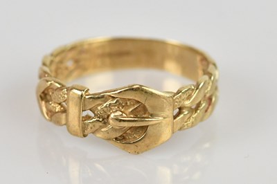 Lot 516 - A 9ct gold buckle ring with woven shoulders,...