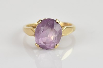 Lot 515 - A 9ct gold dress ring with a four claw set cut...