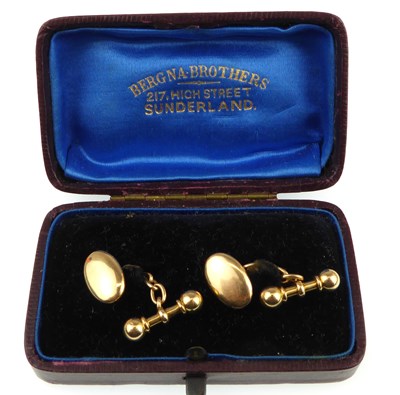 Lot 1196 - A pair of 15ct gold oval cufflinks united with...