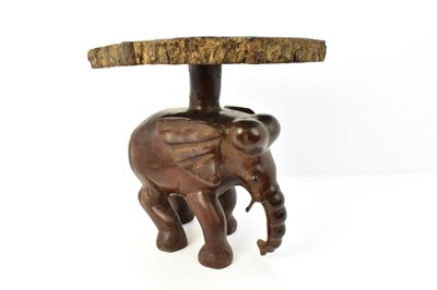 Lot 7 - A carved one-piece coffee table in the form of...