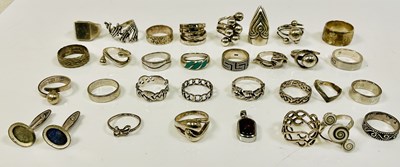 Lot 976 - A collection of silver and white metal rings...