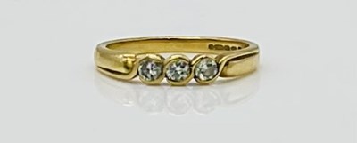 Lot 571 - An 18ct yellow gold three stone diamond ring,...