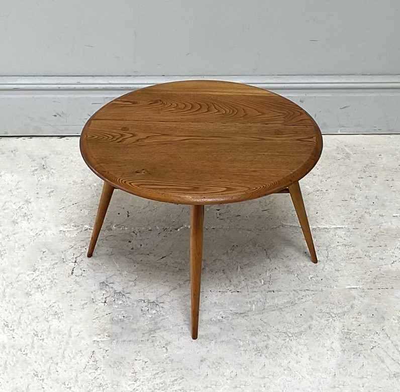 Lot 19 - IN THE MANNER OF ERCOL; a small elm drop-leaf...