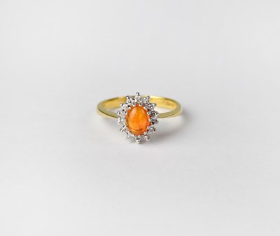 Lot 1016 - An 18ct gold cluster ring set with cabochon...
