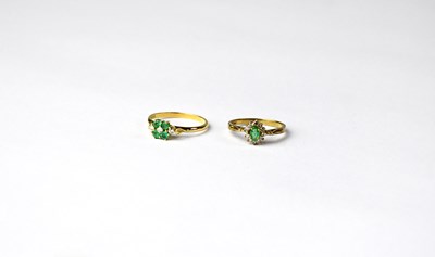 Lot 1103 - Two gold cluster rings set with emeralds and...