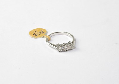 Lot 1004 - An 18ct white gold ring set with three...