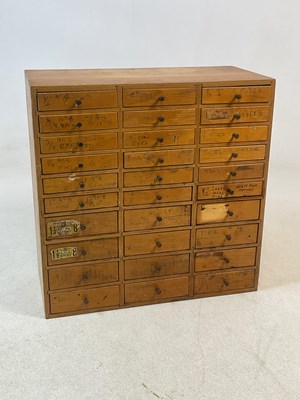 Lot 2846 - A bank of thirty wooden drawers with hardware...