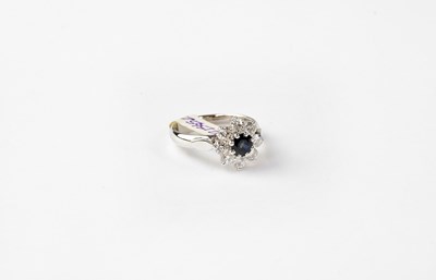Lot 995 - An 18ct white gold sapphire and diamond...