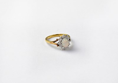 Lot 1014 - An 18ct gold cluster ring set with opal and...