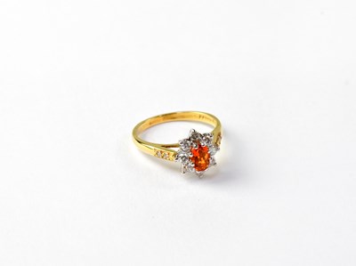 Lot 1015 - An 18ct gold cluster ring set with orange...