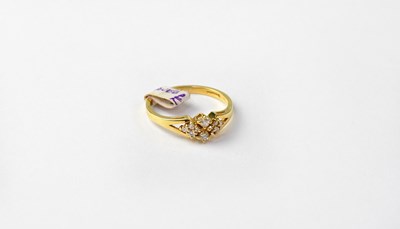 Lot 1018 - An 18ct gold ring set with four diamonds,...