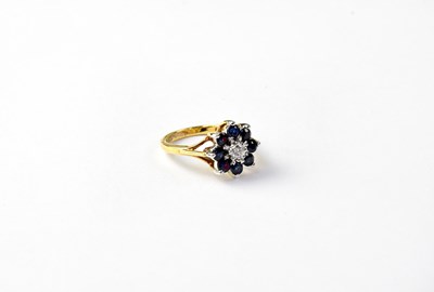 Lot 1013 - An 18ct gold cluster ring set with sapphire...