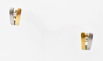 Lot 1114 - A pair of 18ct white and yellow gold earrings...