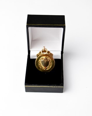 Lot 1208 - A 9ct gold medal with rose gold shield and...