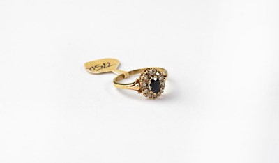 Lot 1048 - A 9ct gold cluster ring set with sapphire and...
