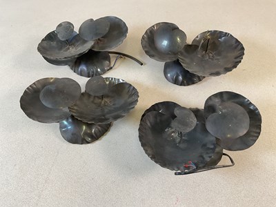 Lot 2731 - A set of four metal lily wall lights.
