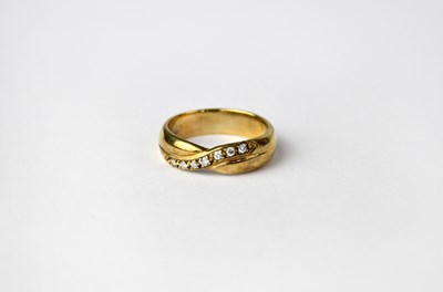 Lot 1073 - A 9ct gold diamond set wedding band, stamped...