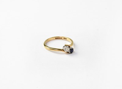 Lot 1055 - A 9ct gold ring with a diamond and a sapphire...